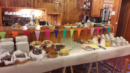 a table topped with plates and bowls of food at Livadaki Village in Megáli Kápsi