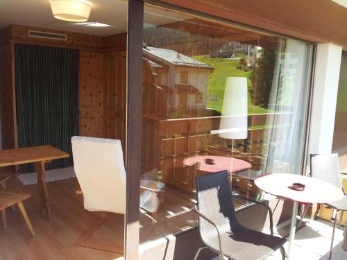 a room with a table and chairs and a window at Ferienwohnung Club House F4 in Surlej