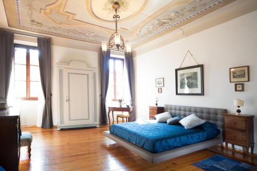 a bedroom with a blue bed in a room at San Giacomo Bed & Breakfast in Verona
