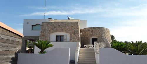 a house with a staircase leading up to it at La stanza del paradiso in Torre Pali 