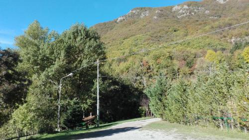 a road with a street light on the side of a mountain at Agriturismo Rio Ricco in Busana