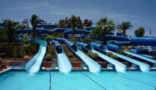 a water slide in a pool at a resort at Apart Great Sea View in Alvor