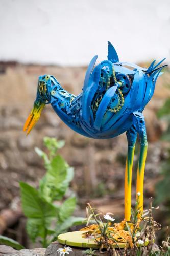 a blue statue of a bird on a surfboard at La Colina Hotel Cottage in Bogotá