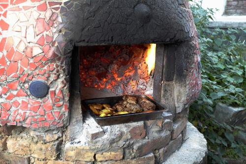 a brick oven with food cooking in it at La Colina Hotel Cottage in Bogotá