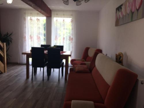 a living room with a couch and a table and chairs at Cabana 7 Brazi in Poiana Mărului