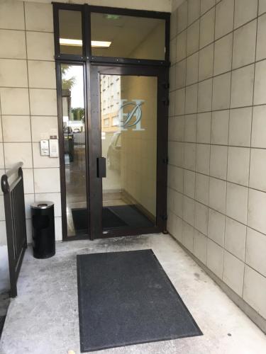an entrance to a building with a revolving door at Hotel Dorele in Montargis