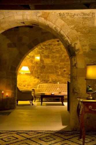 a living room with a table and a couch at Mystic Hotel - Adults only in Rhodes Town