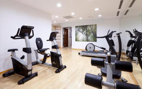 a gym with several treadmills and exercise bikes at Laguna Nivaria Hotel & Spa in La Laguna