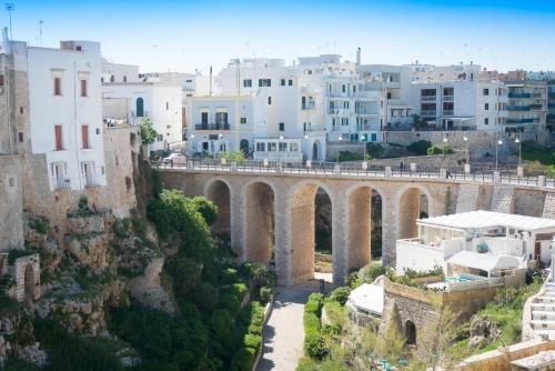 an old stone bridge in a city with buildings at Covo dei Saraceni in Polignano a Mare