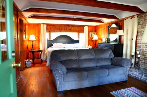 a living room with a couch and a bed at The Pines Cottages in Asheville