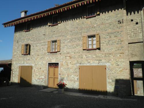 a large brick building with two entrances and two doors at Agriturismo Cavazzone in Regnano