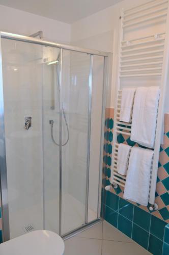 a bathroom with a shower with white towels at Le Vele in Agropoli