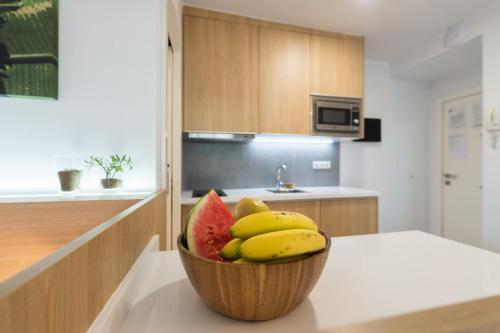 a bowl of fruit sitting on a counter in a kitchen at Living Las Canteras Homes - FRONT-LINE BEACH in Las Palmas de Gran Canaria