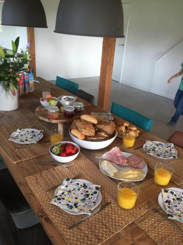 a wooden table with food on top of it at B&B Erve ten Dam in Ambt Delden