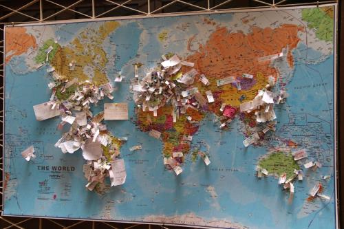a map of the world pinned to a wall at Check Inn Bed and Breakfast in Cuenca