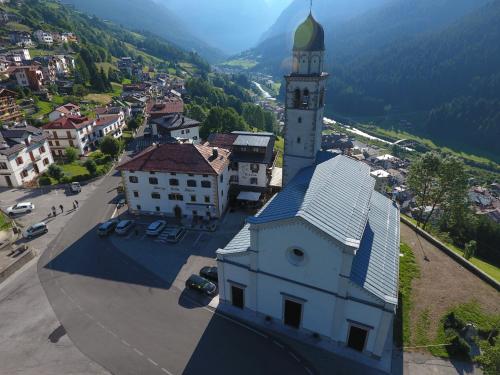 an aerial view of a building with a clock tower at Albergo Stella Alpina in San Pietro di Cadore