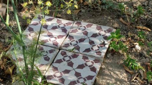 a stone slab with a flower pattern on the ground at Villino L'Aranceto Sorrentino in Meta