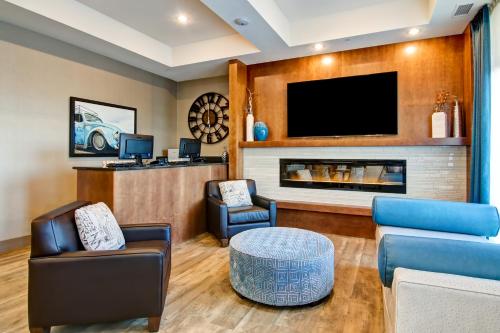 a living room with a fireplace and a tv at Canalta Martensville in Martensville
