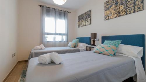 two beds in a room with blue and white at Nora Nice in Moraira