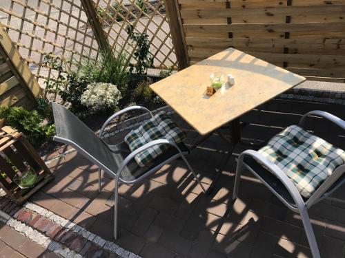 a wooden table and chairs on a patio at Leezdorfer Hof in Leezdorf