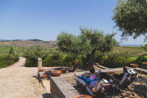 a group of people sitting in chairs in a garden at Quinta da Barroca Douro Valley in Armamar