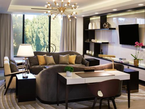 a living room with a couch and a table at The London West Hollywood at Beverly Hills in Los Angeles
