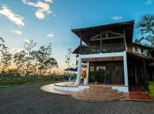 a house with a porch and a balcony at Finca Hotel Casa Nostra, Villa Manuela in Quimbaya