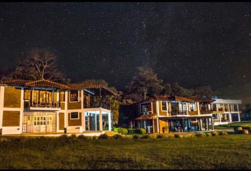a group of houses under a starry sky at Finca Hotel Casa Nostra, Villa Manuela in Quimbaya