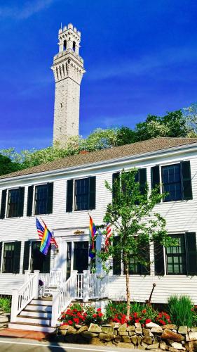 a white building with a clock tower and flags at The Clarendon House in Provincetown