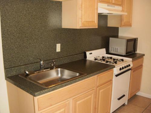 a kitchen with a sink and a stove at Sunrise Motel in Seaside Heights