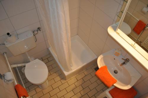 巴特維爾東根的住宿－Haus Mariann，浴室配有盥洗盆、卫生间和浴缸。