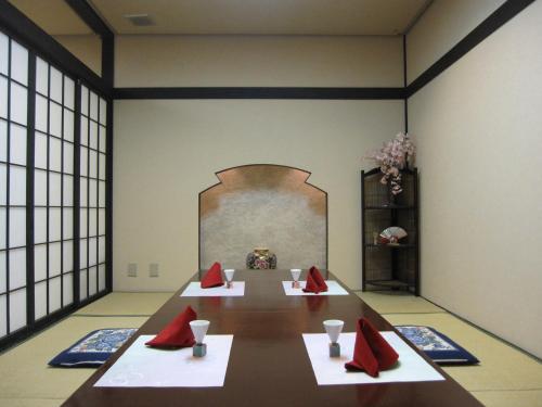 a conference room with a long table with red napkins at Saku Grand Hotel in Saku