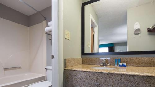 a bathroom with a sink and a mirror at Best Western Inn Florence in Florence