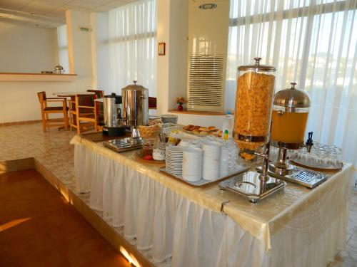 a buffet with food on a table in a room at Telhinis Hotel & Apartments in Faliraki