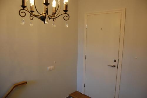 a chandelier hanging over a room with a door at Ontic Wellness Apartments in Tartu