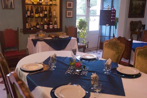 a table with plates and glasses on a blue table cloth at Le Clos des Cèdres b&b in La Rochefoucauld