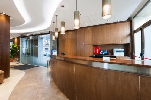 an office lobby with a reception counter and glass doors at Hotel Santa Marta in Barcelona