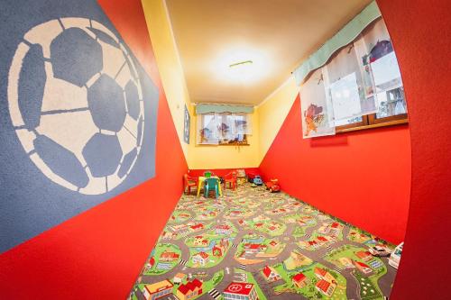 a childs room with a bed with a soccer rug at U Repy in Bańska