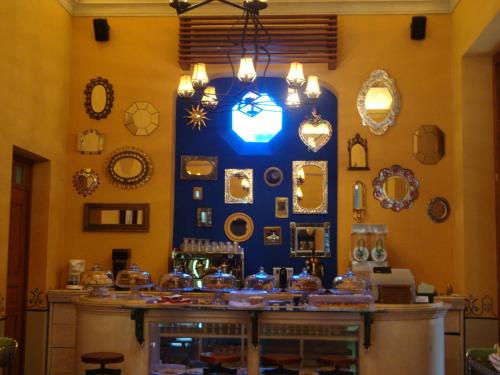 a room with a counter with plates and mirrors at Hotel Boutique Casa San Angel in Mérida