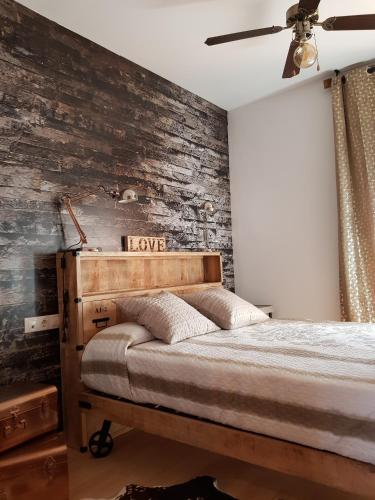 a bedroom with a brick accent wall with a bed at Apartment Beach Front Canet in Canet de Mar