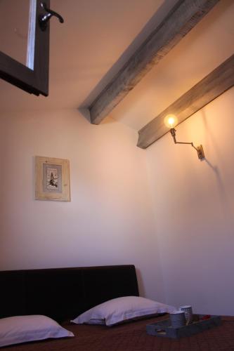 a bedroom with a bed and a light on the wall at Appartement Les Saintes au bord de mer in Saintes-Maries-de-la-Mer