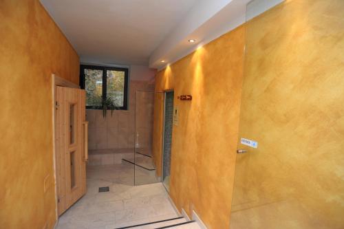 a bathroom with a shower and a glass door at Hotel Relais Valle Orientina in Pitigliano
