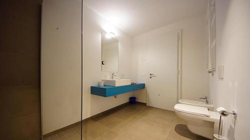 a bathroom with a toilet and a sink and a mirror at Alpin Relais B&B Villa Melisse in Colfosco