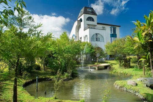 a building with a river in front of it at Phil Garden Homestay in Dongshan