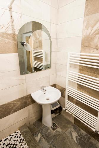 a bathroom with a sink and a mirror at Daiana Residence Turda in Turda