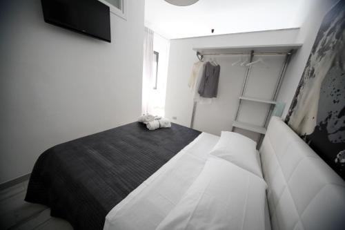 a bedroom with a large bed and a closet at SOHO Suite in Fisciano