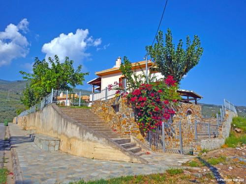 a house with some flowers on the stairs at Kala Nera Panorama in Kala Nera