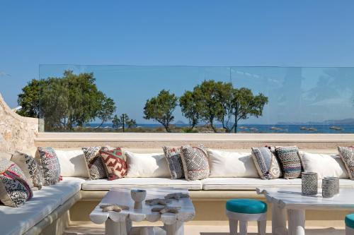 a white couch with pillows and tables in a room at White Pearls-Adults Only Luxury Suites in Kos Town