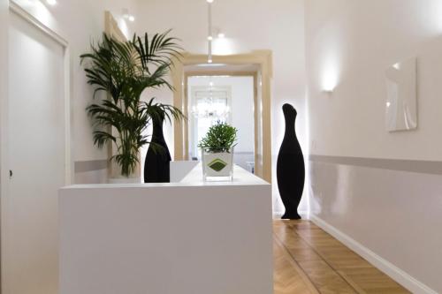 a room with vases and plants on a white shelf at Residenza Degli Artisti in Trieste