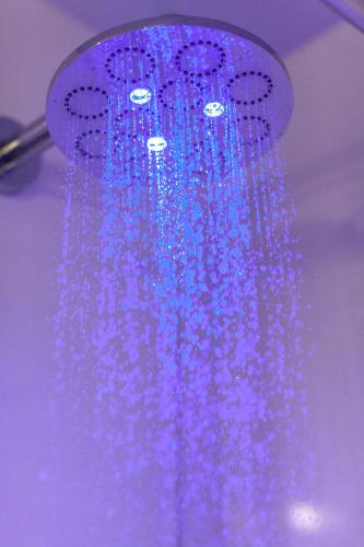 a bunch of blue lights hanging from a ceiling at Hotel Il Guercino in Bologna